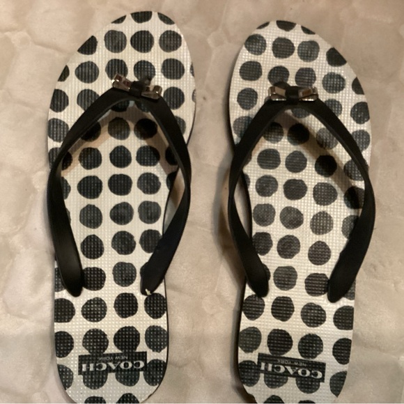 Coach flip flops in white and black polka dots straps adorned with silver bows. - Picture 2 of 6